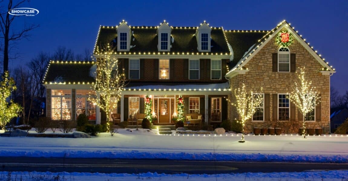 Professional Christmas lights installed on a home during the winter season.