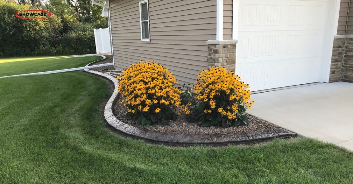 Is Concrete Curbing Worth It? A Minnesota Homeowner’s Guide to Lasting Curb Appeal 1 Decorative concrete curbing improving curb appeal in a suburban Minnesota yard