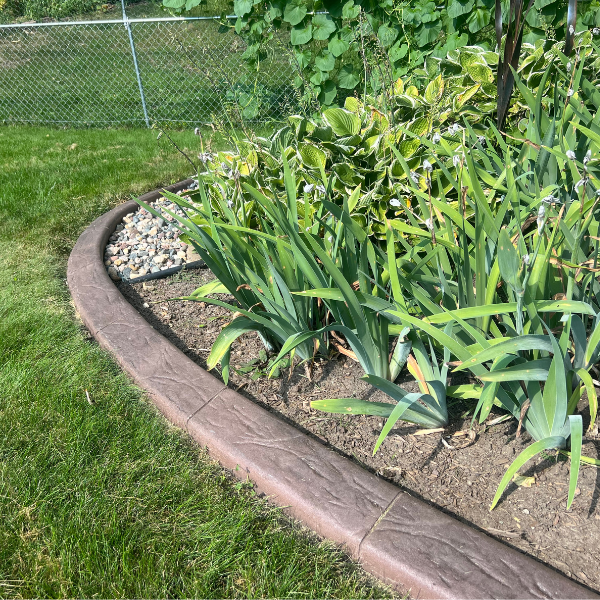 Decorative curbing styles and edging applications Variety of decorative concrete curbing types and textures installed in garden beds