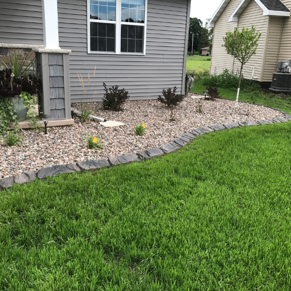 Front yard with concrete curbing enhancing curb appeal