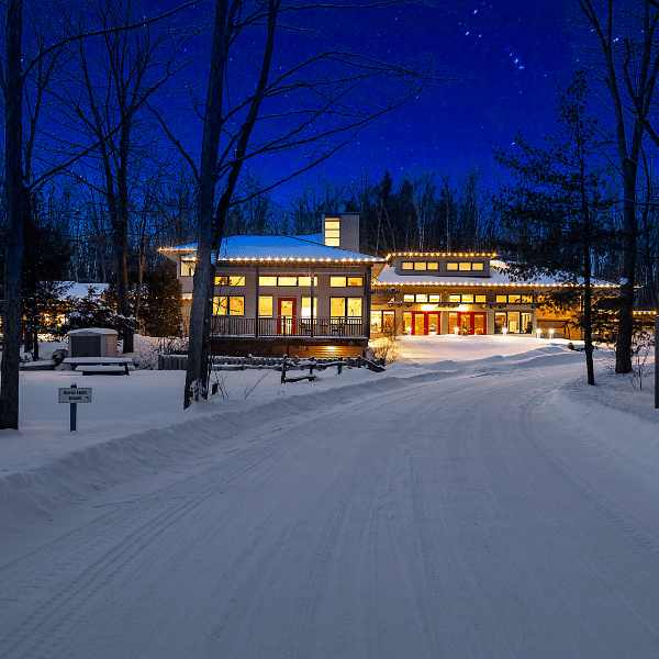 Close up of energy efficient LED holiday lights installed outdoors in winter snow