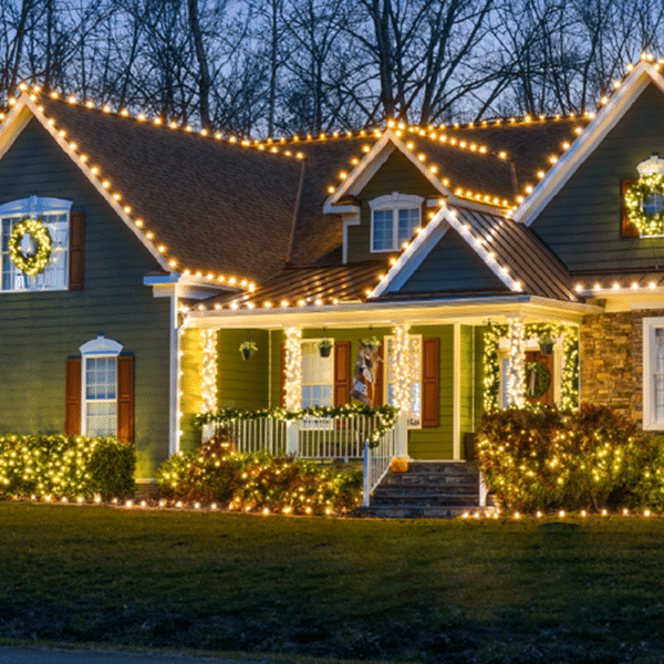 Christmas lights on a home in heavy Minnesota snow.