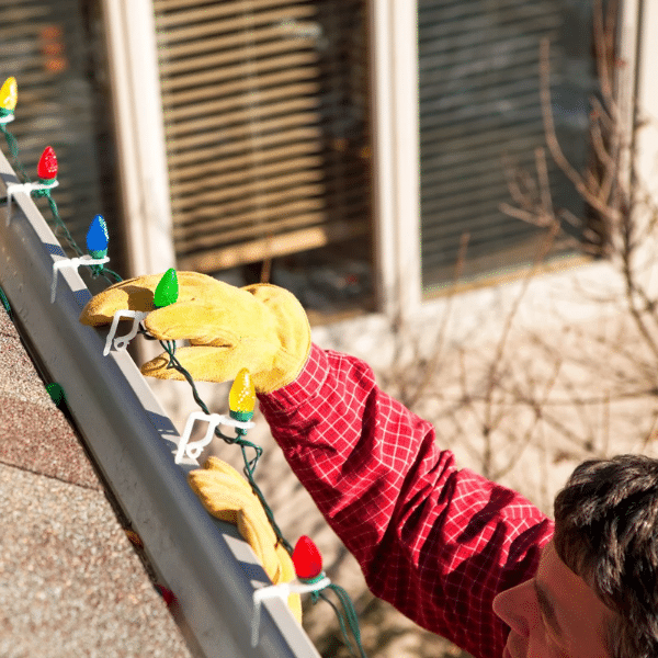 Showcase Services team installing professional Christmas lighting display on a residential home